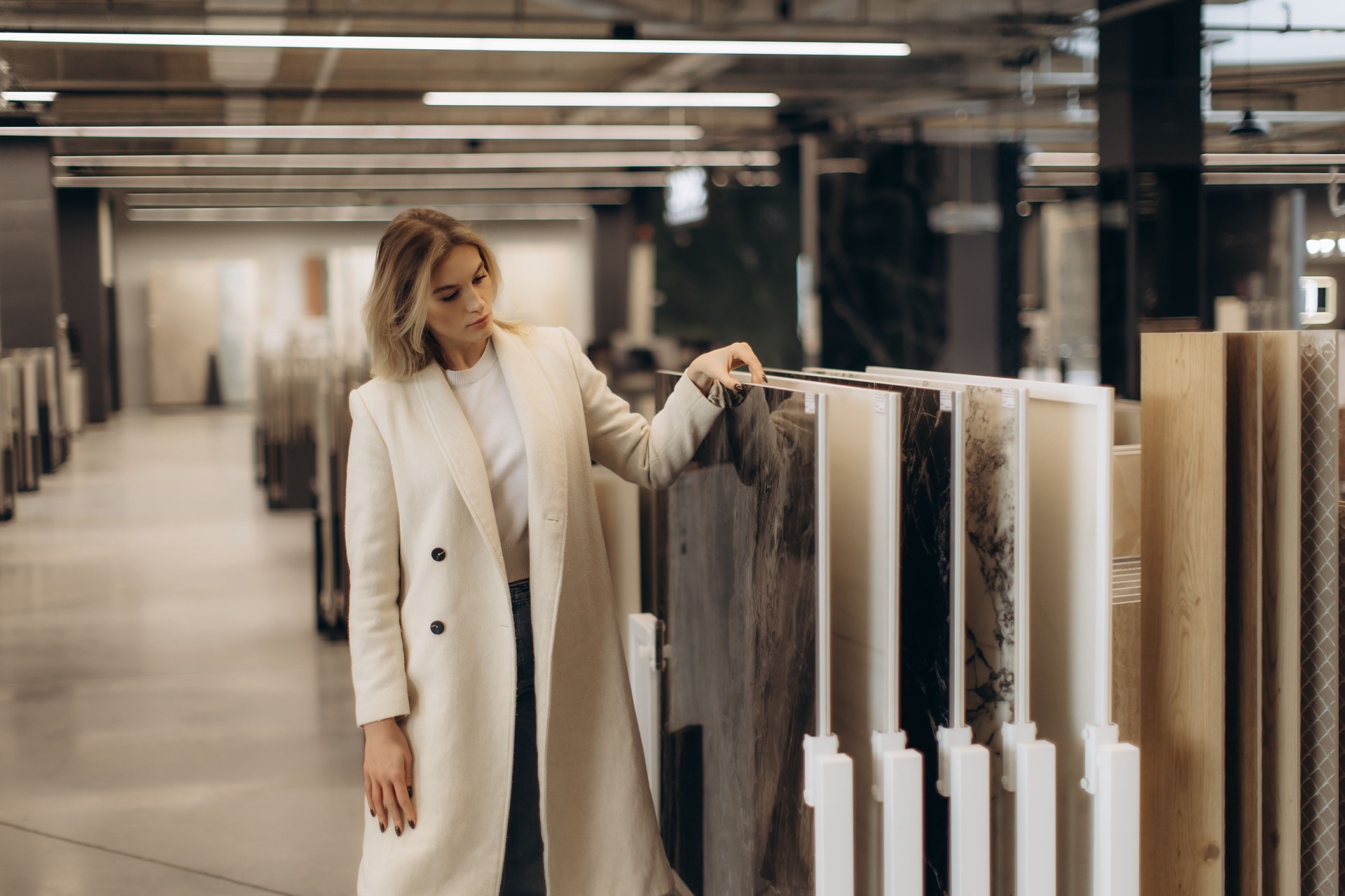Woman Browsing Modern Interior Decoration Materials in a Showroom Setting